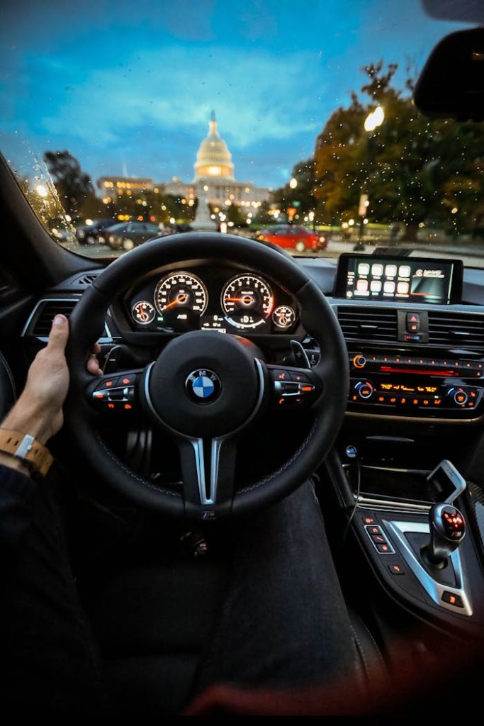 pexels-photo-2526128 Person Holding Bmw Steering Wheel